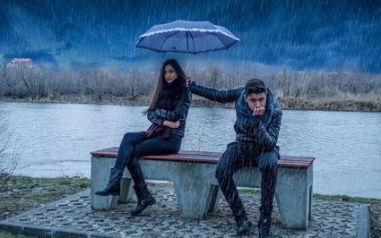 Caring couple love in rain