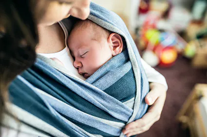 Unrecognizable young mother with her son in sling picture id614209062