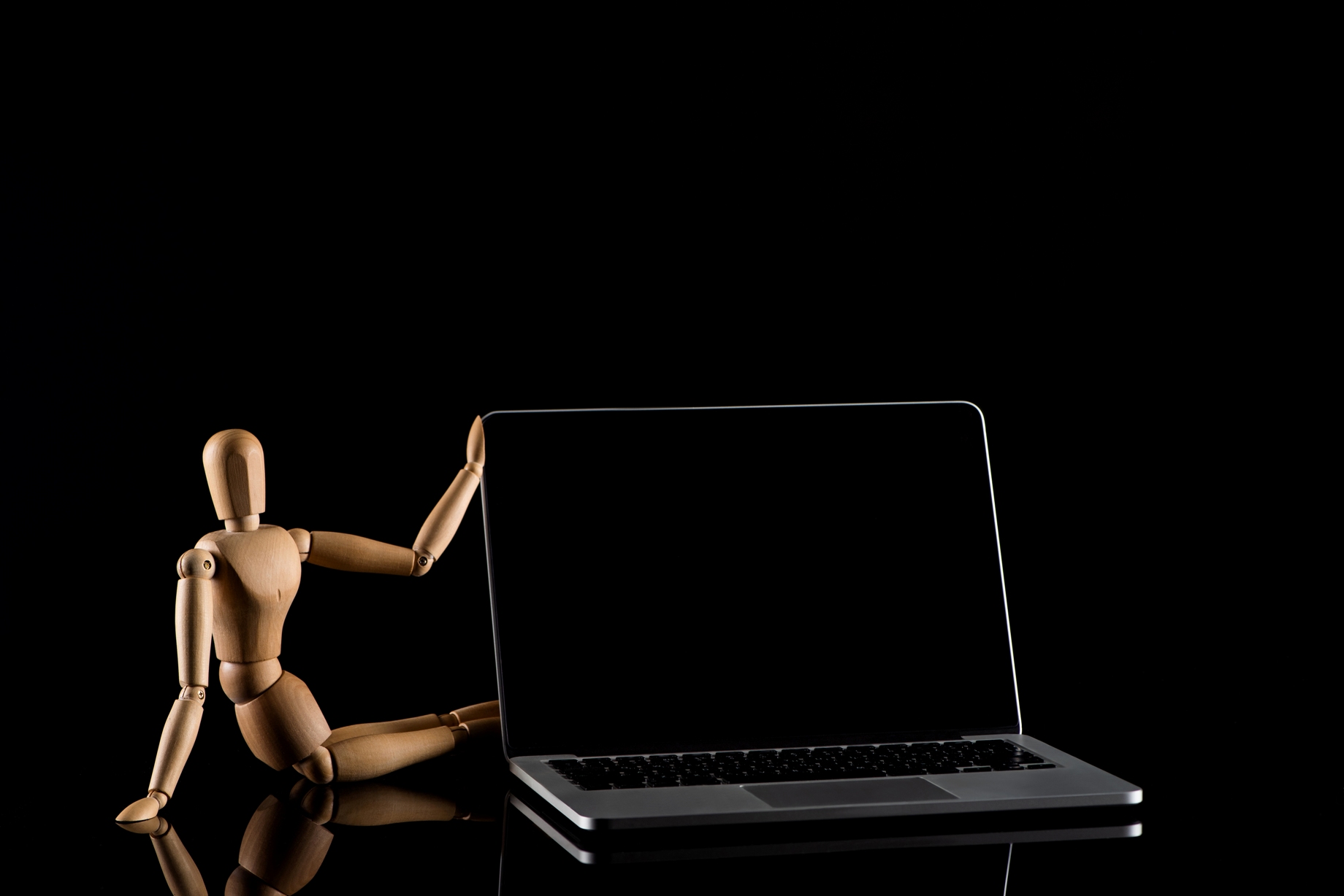 Crello 354064294 stock photo wooden doll sitting position laptop