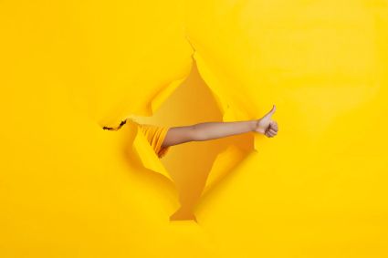 Female-hand-pointing-showing-torn-yellow-paper-hole-background-breaking-breakthrought-with-gesturing-concept-celebration-shopping-proposal-sales-ad-copyspace-promotions-discounts