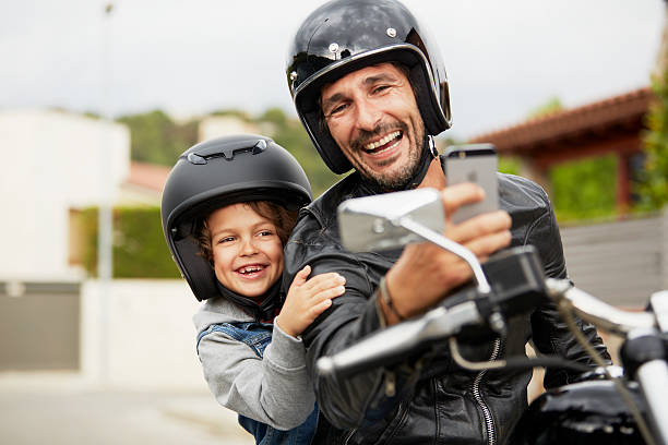 Father-and-son-taking-self-portrait-on-motorbike-1-