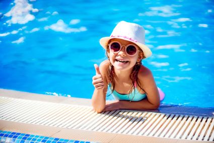 Happy girl sunglasses hat with unicorn show thumb up outdoor swimming pool luxury resort summer vacation tropical beach island