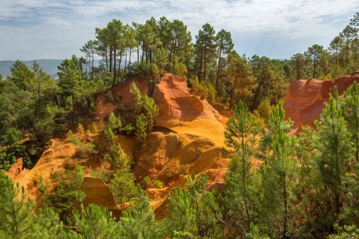 Roussillon-ochre-quarries-sunlight-cloudy-sky-france