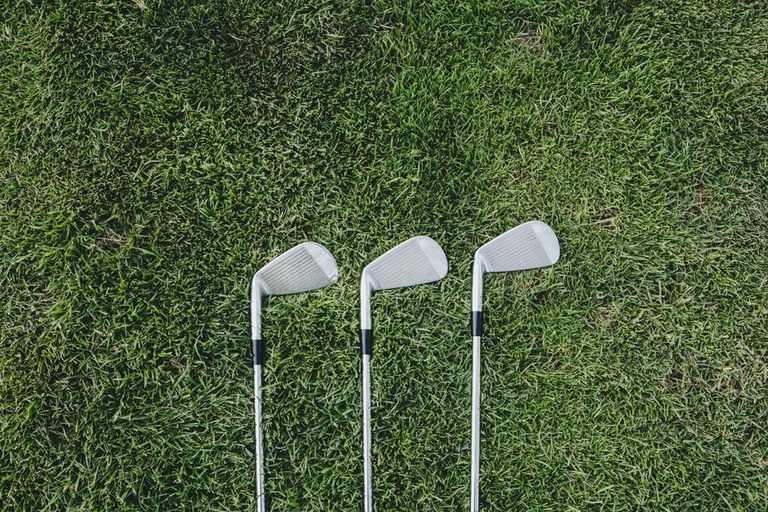 Three golf clubs on green 925x