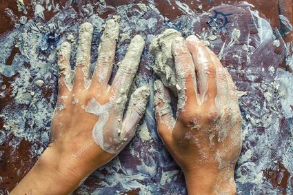 Depositphotos 99281148 stock photo hands in clay foto