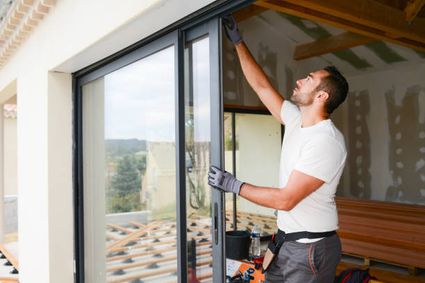  photos handsome young man installing bay window in a new house construction picture id945456460