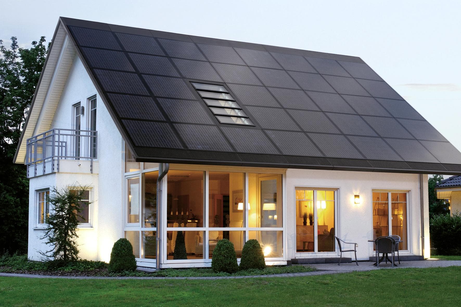 Fashionable reasons that home solar energy is a great alternative as well black sloping roof and green grass in backyard min