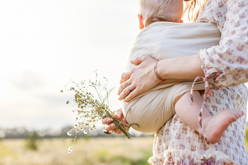 Little baby boy and his mother walking in the fields during summer picture id1042088542