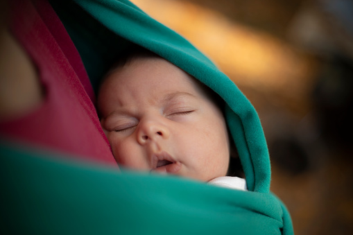 Newborn baby sleeping in the sling picture id1185083355