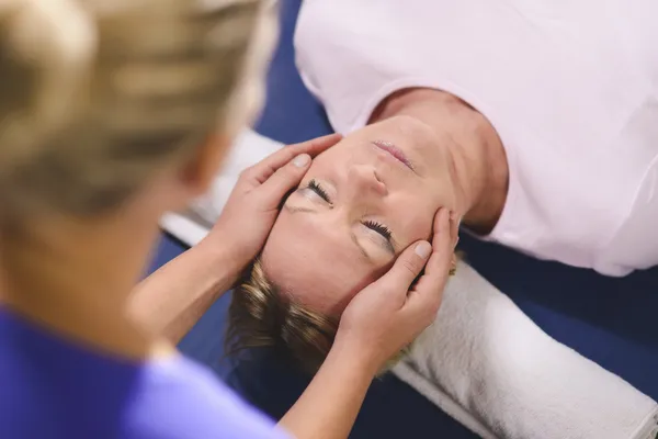 Depositphotos 21281637-stock-photo-young-therapist-doing-reiki-therapy