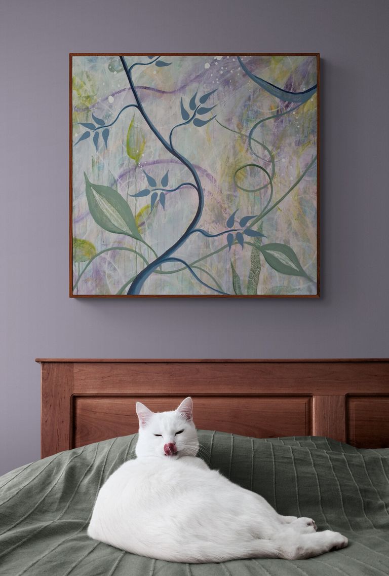 Cute white cat lying on bed