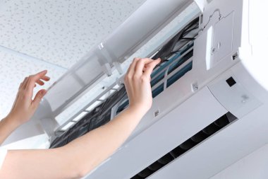 Depositphotos 176497300-stock-photo-young-woman-cleaning-air-conditioner