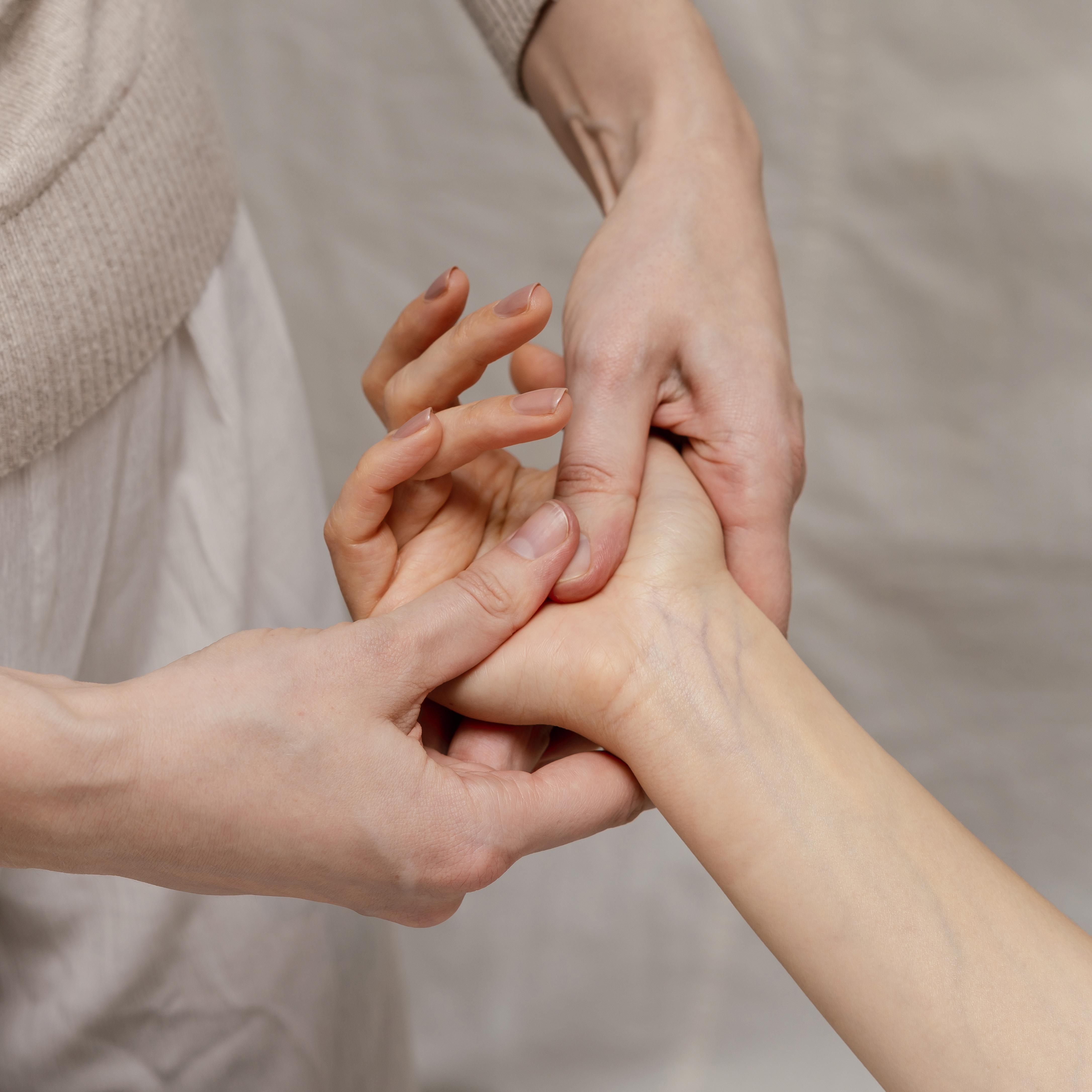 Close-up-therapist-massaging-palm-1-