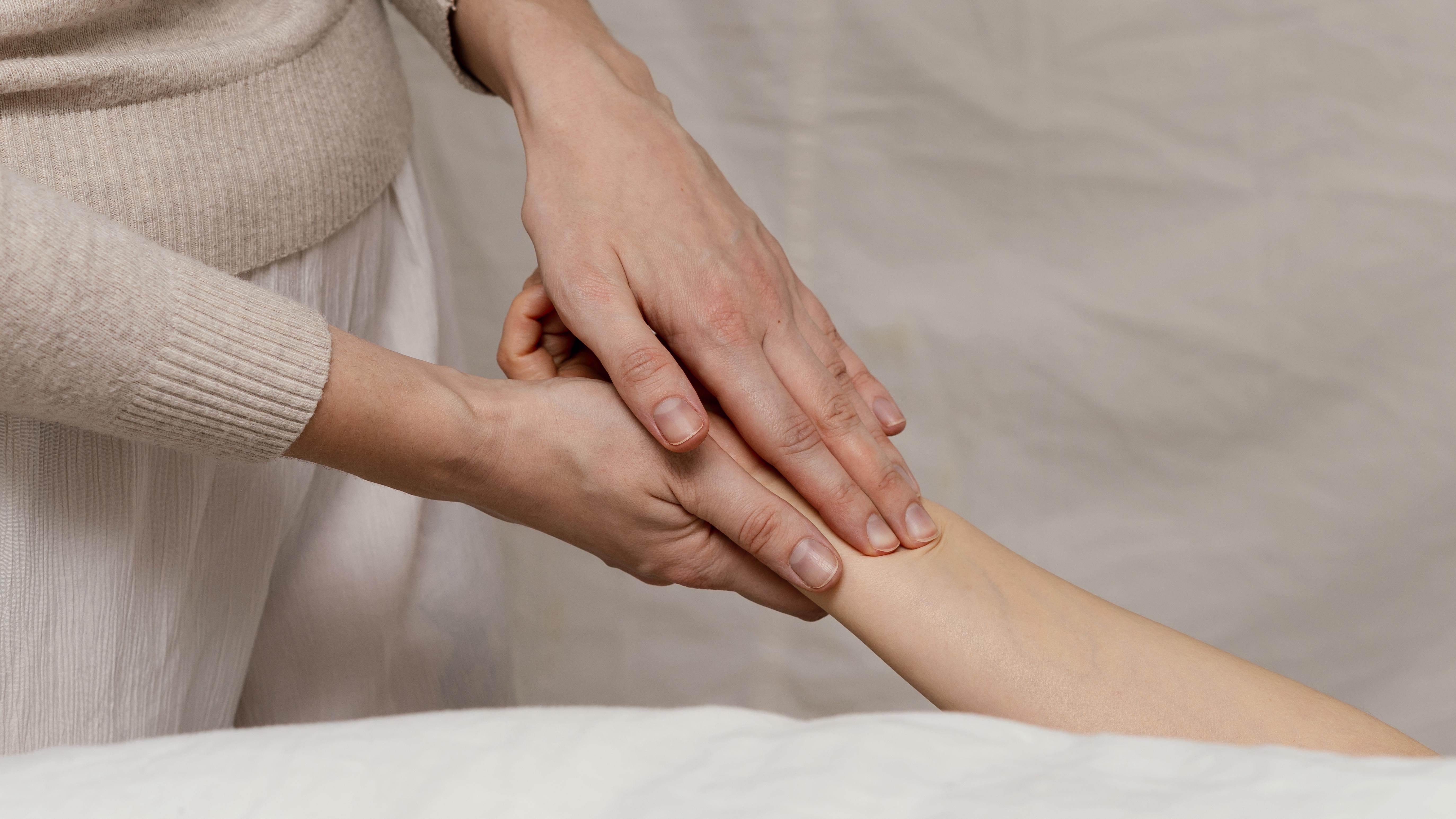 Close-up-therapist-massaging-hand