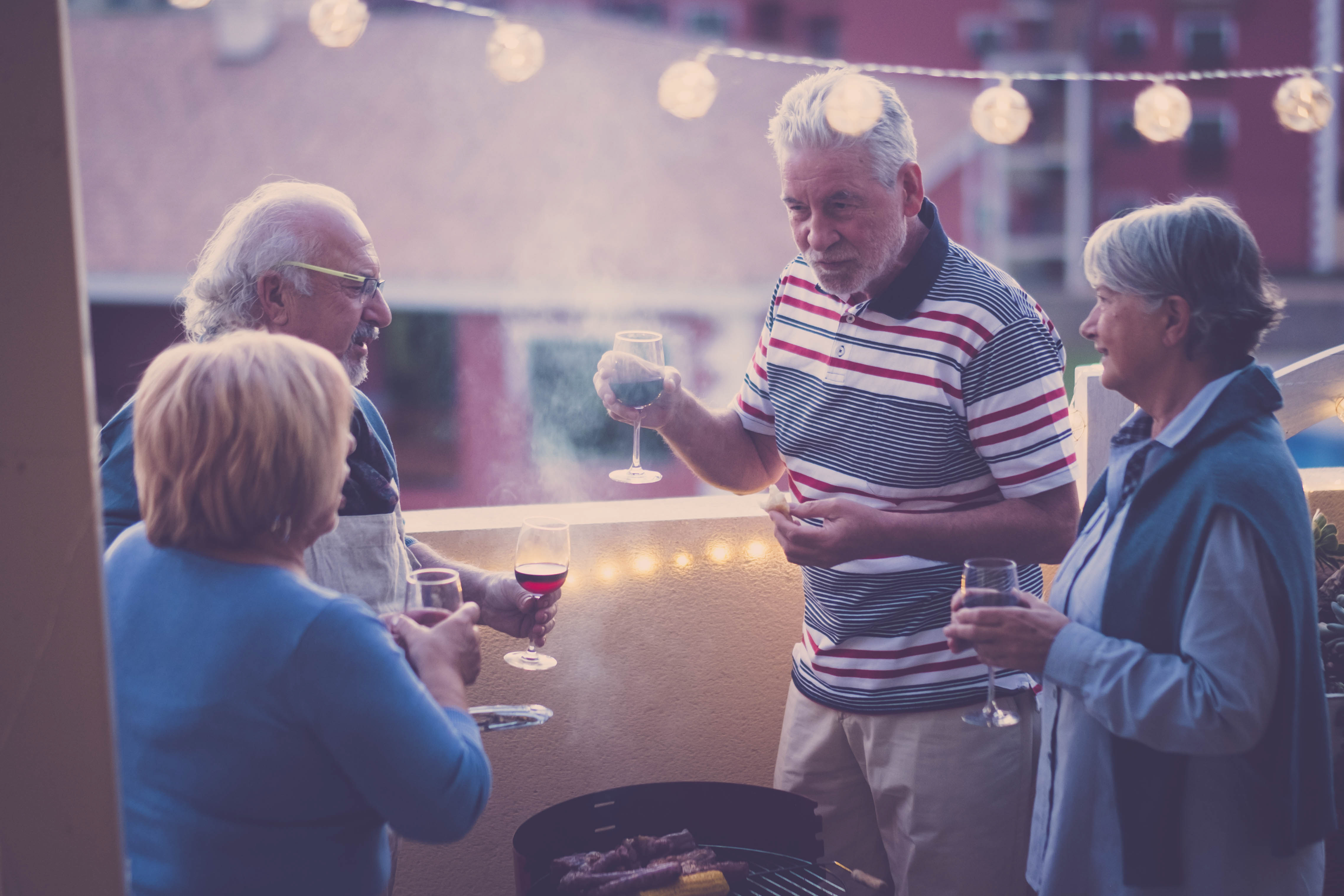 Senior-couples-talking-while-having-wine-restaurant