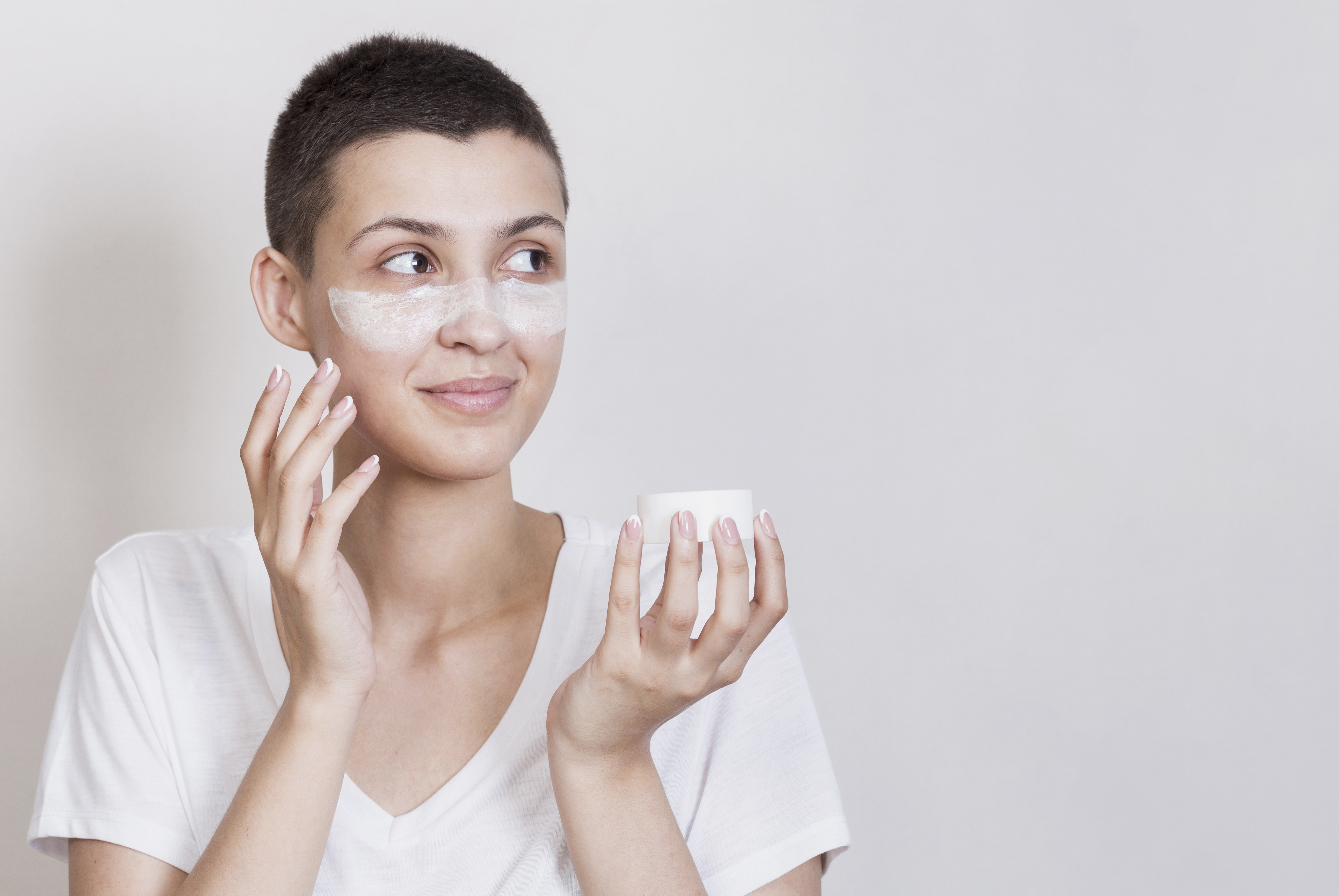 Woman-using-skin-cream-her-face