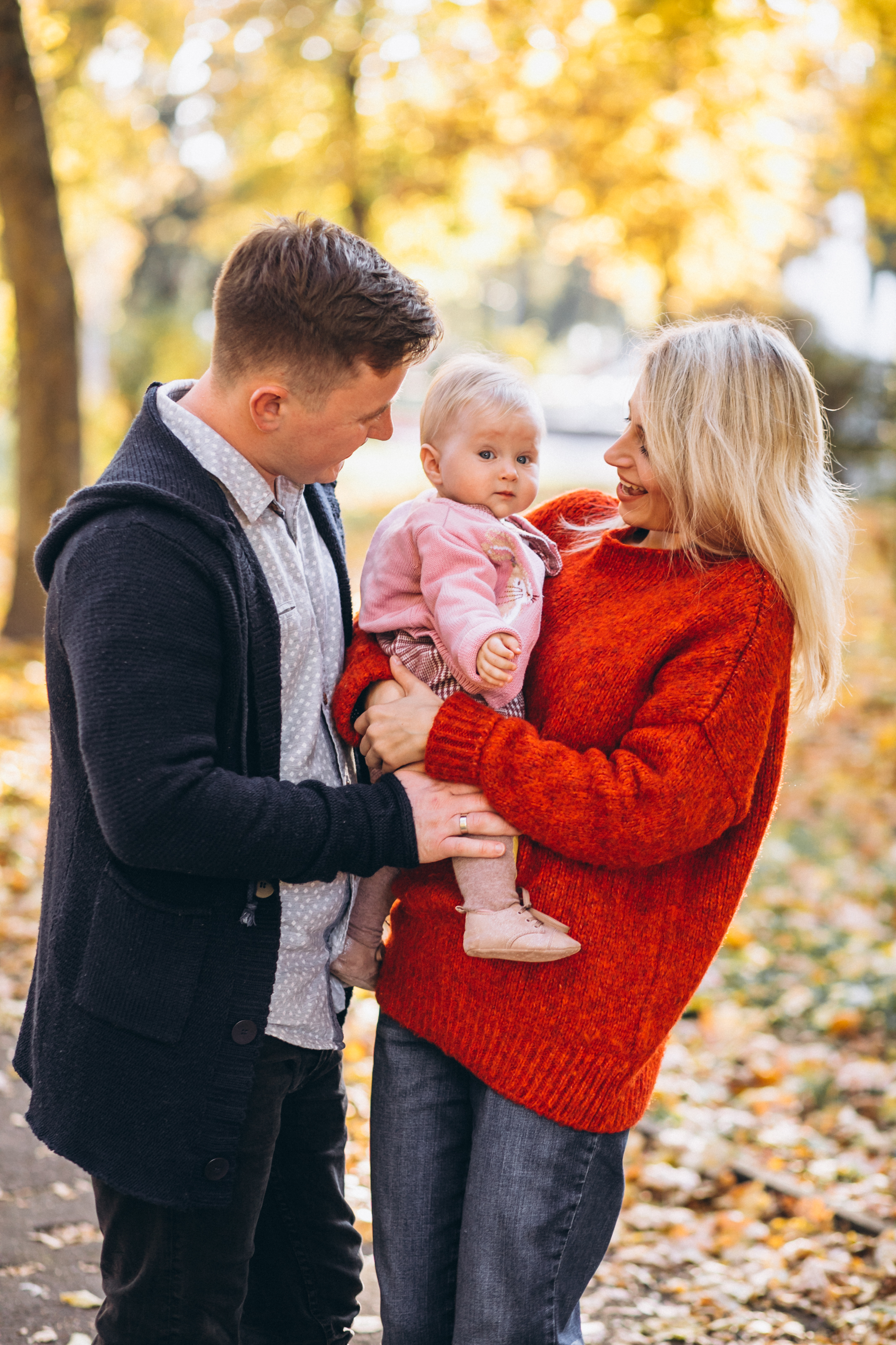 Family-with-baby-daugher-walking-autumn-park