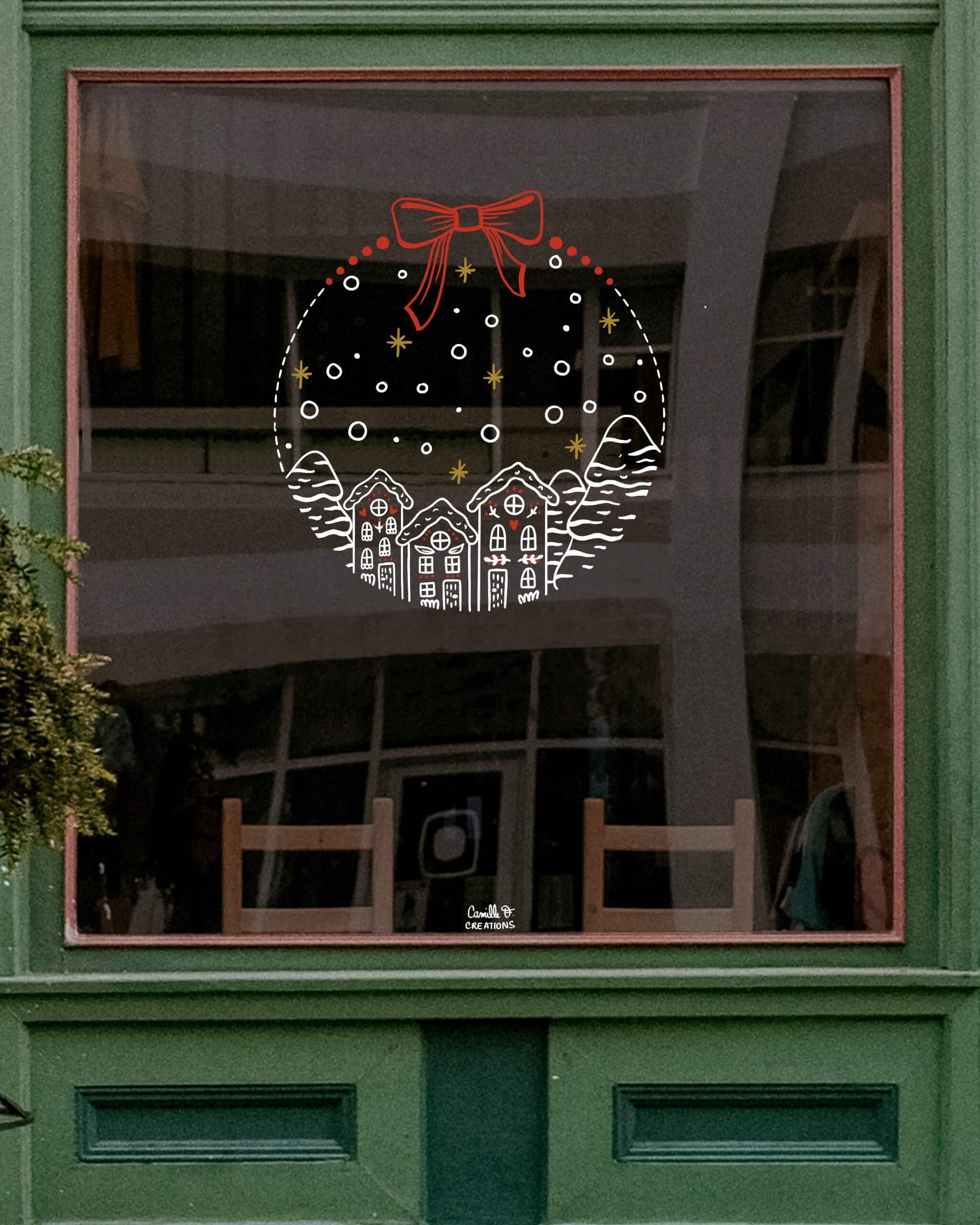 Peinture sur vitrine à Paris ou dans les Yvelines sur le thème de Noël : Boule de Noël avec paysage enneigé