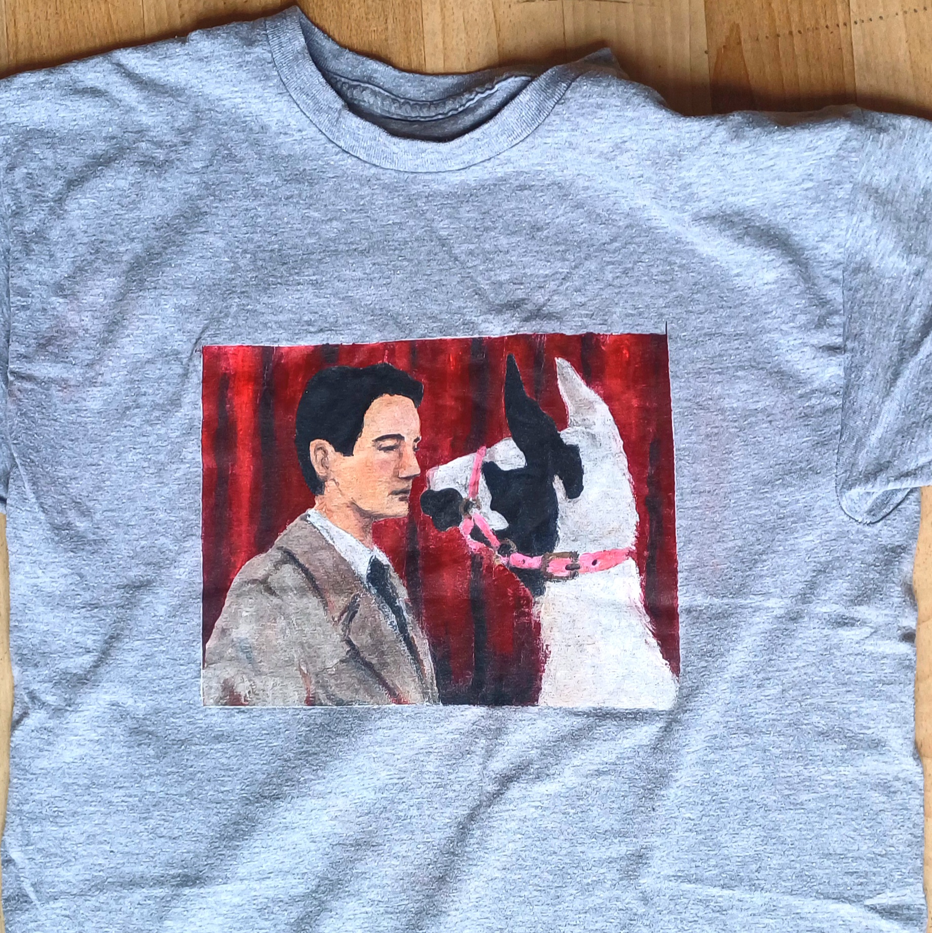 t-shirt personnalisé peint à la main représentant l'agent Dale Cooper, un personnage de la série télévisée de David Lynch Twin Peaks, face à un lama devant un fond de rideau rouge