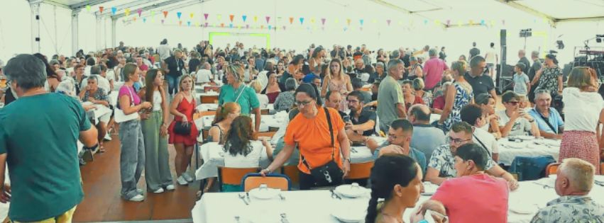 châpiteau avec grandes tablées, beaucoup de monde.