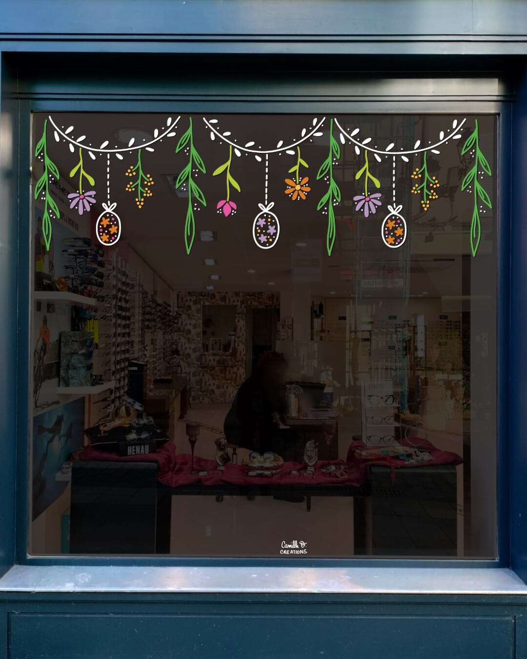 Peinture sur vitrine à Paris et dans les Yvelines, guirlande de Pâques pour un décor de vitrine sur le thème du printemps