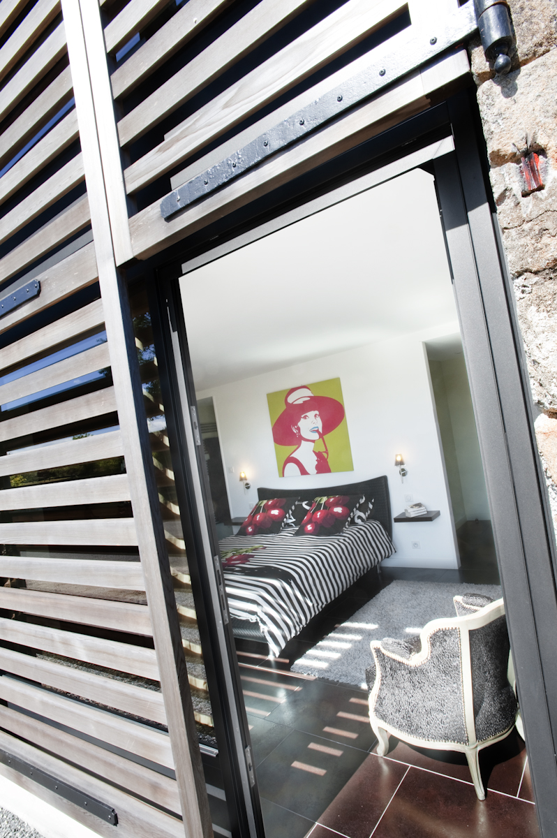 Chambre moderne avec vue extérieure boisée dans le cadre du domaine