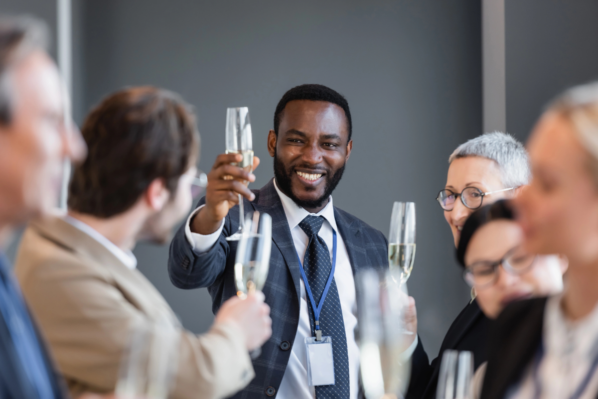 Vistacreate 469517384 stock photo selective focus african american businessman holding champagne glass interracial colleagues