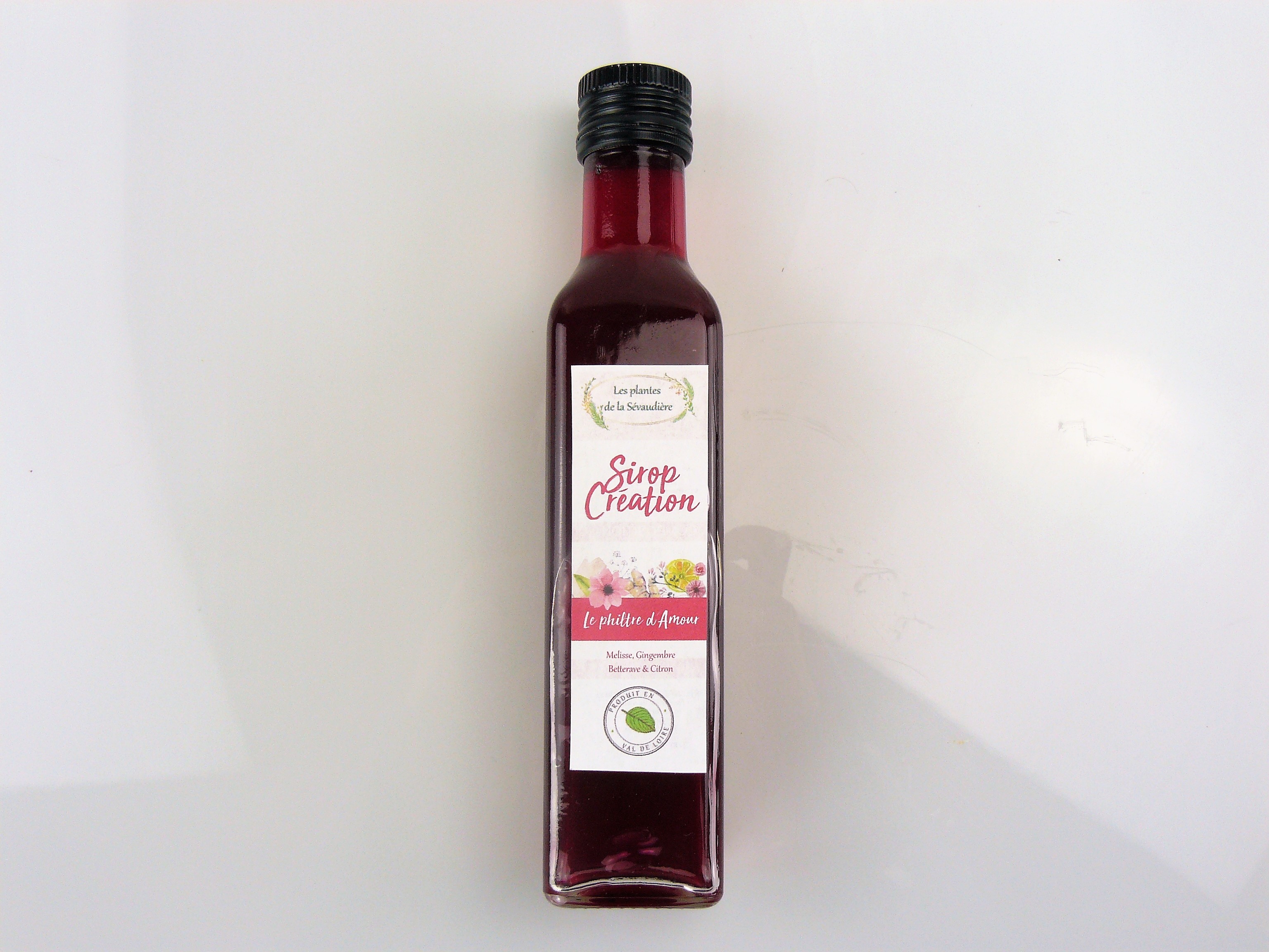 Sirop le philtre d'amour 25cl - 5€50
Un sirop tendre et acidulé, comme l'amour ! Si on prend le temps de le savourer, chaque note se dévoile délicatement au palais (betterave, gingembre, mélisse, citron). Un mélangeant savant est équilibré, ou personne ne prend le dessus. C'est ça l'amour !

Conseils de préparation

Sucrer des laitages (yaourts, faisselle…), 2cl de sirop pour un verre d'eau fraîche, ou bien faire des milkshakes, des cocktails ou des kirs.

Composition : sucre bio, feuilles de mélisse bio, racine de gingembre bio, jus de betterave et de citron bio.