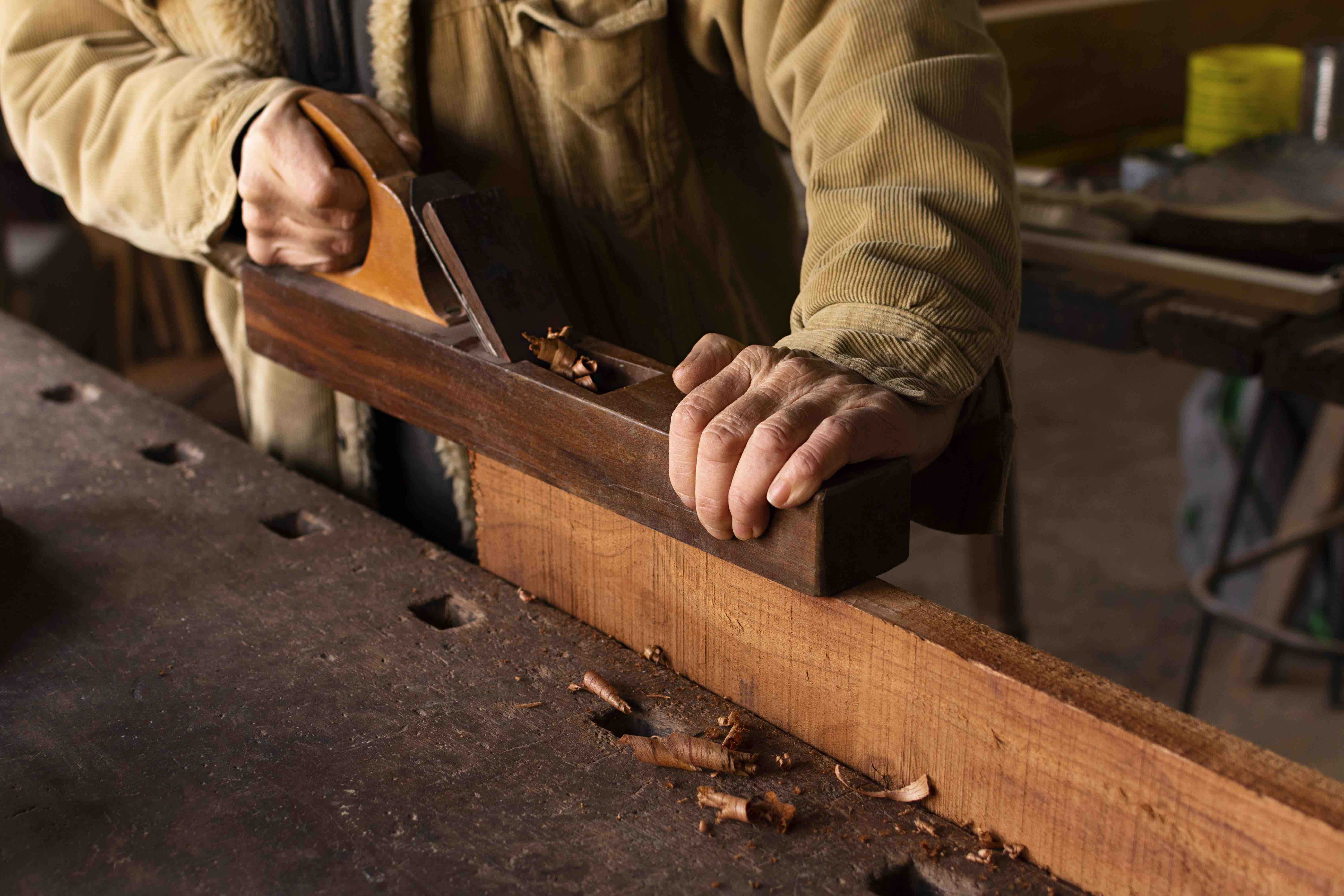 Carpenter-working-on-woodworking-side-view